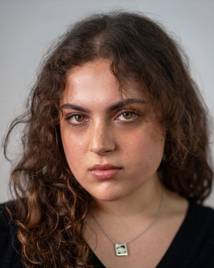Portrait of Talia Wren with long, curly brown hair